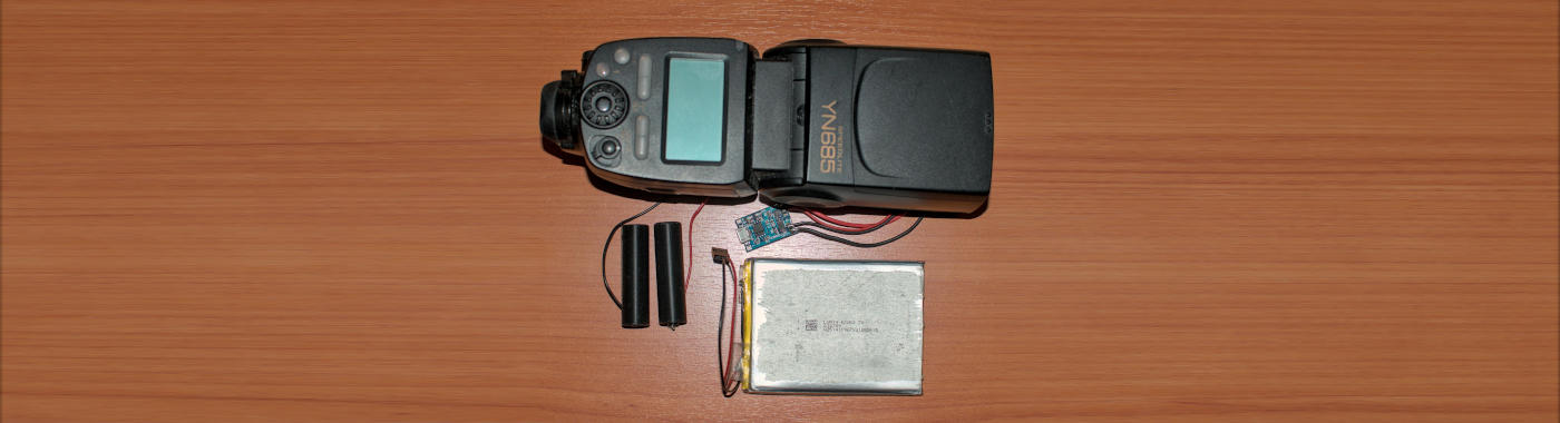 A photo of a camera flash, a li-ion battery and some electronics